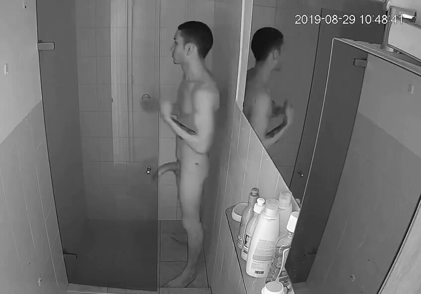 Spying on an uncut horsehung guy erect in the shower