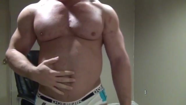 Sexy bodybuilder rubs belly
