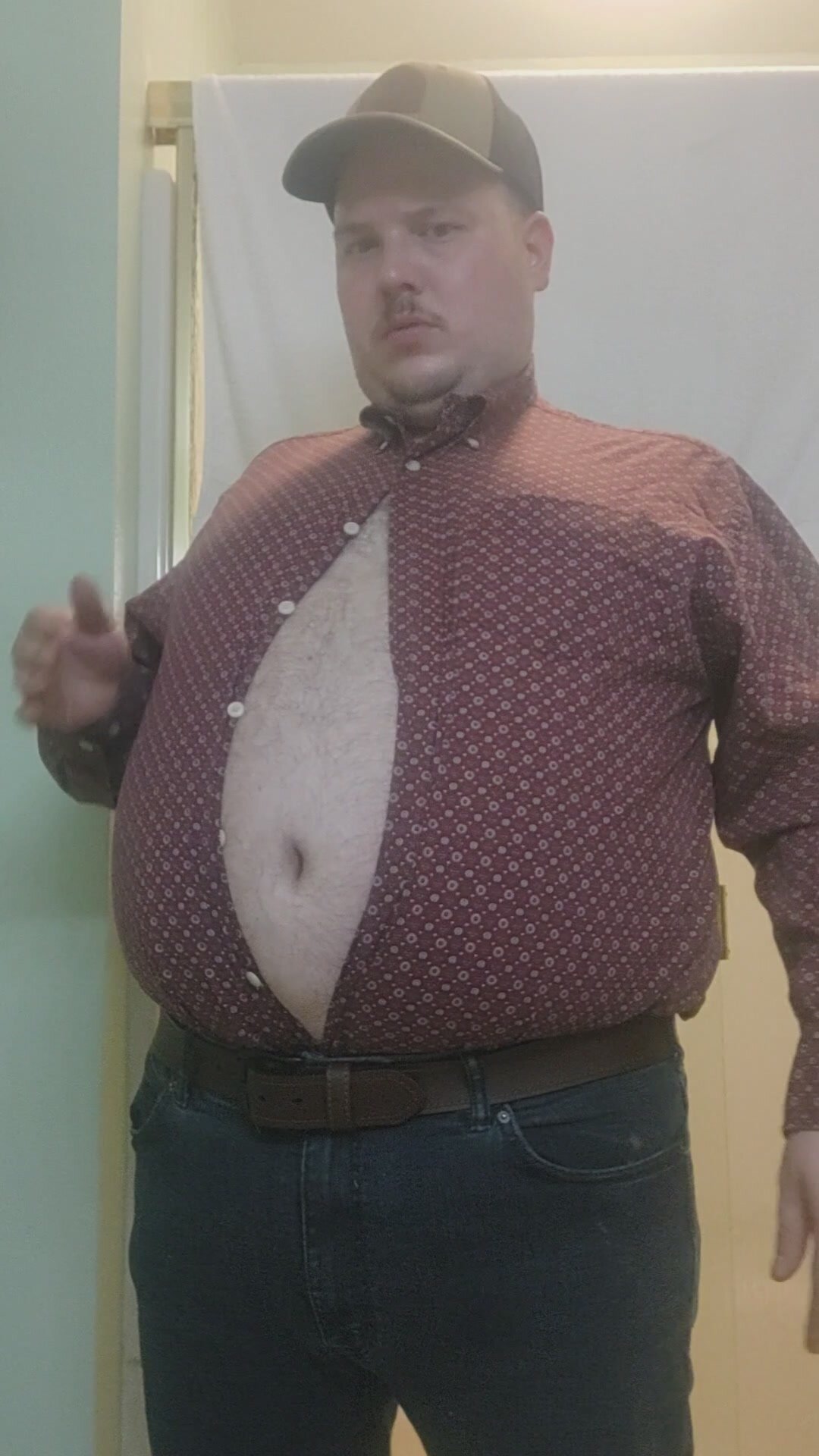 Full belly trying on tight clothes