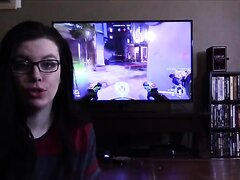 Girl distracts guy playing video games