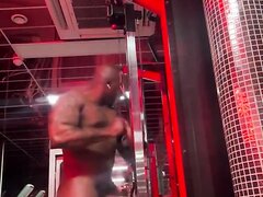 Naked bodybuilder working out HARD in sauna gym
