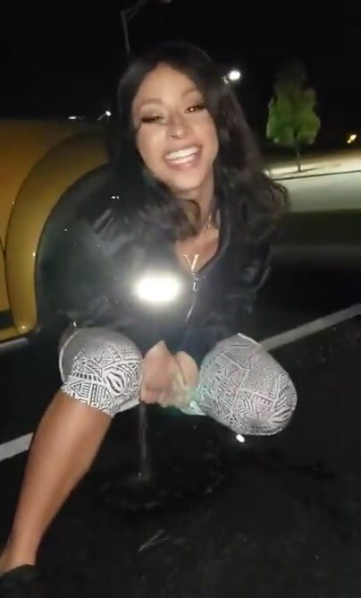 Sexy babe pees outside of the car in parking lot