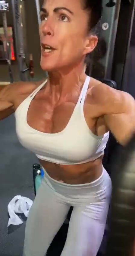 Strong woman works out her chest