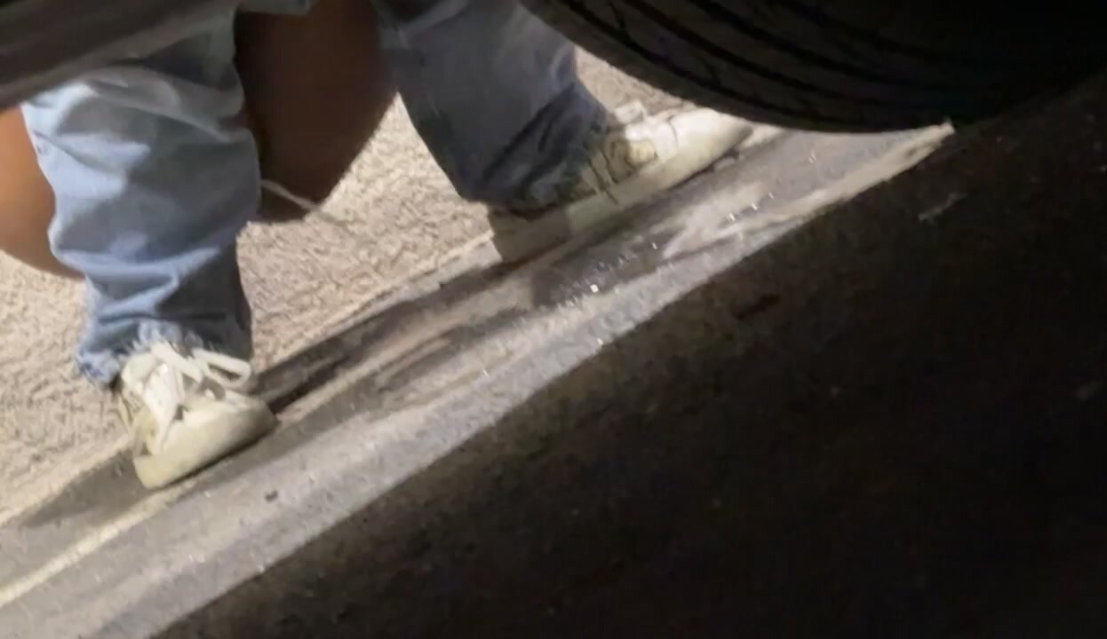 Pussy shown as a girl pees next to a car