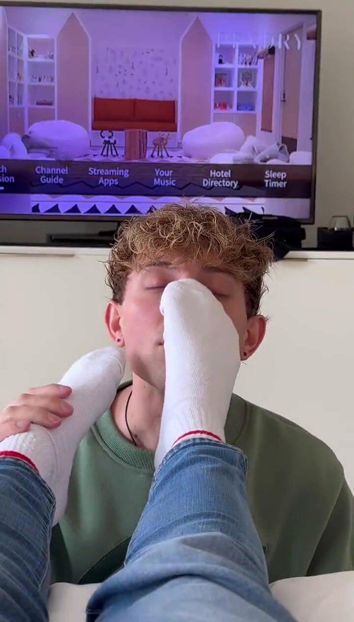 Young dude sniffing white socks