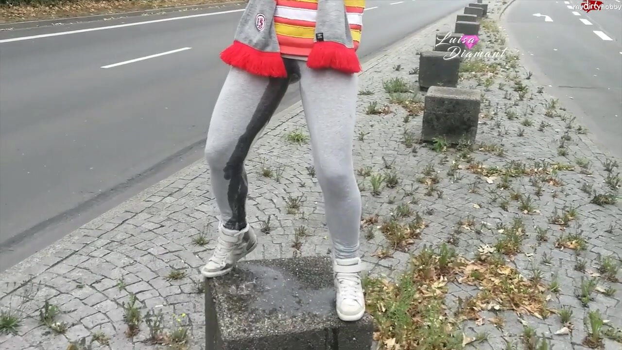German wetting her pants in a traffic median