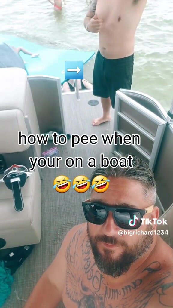 A guy is pissing on a boat