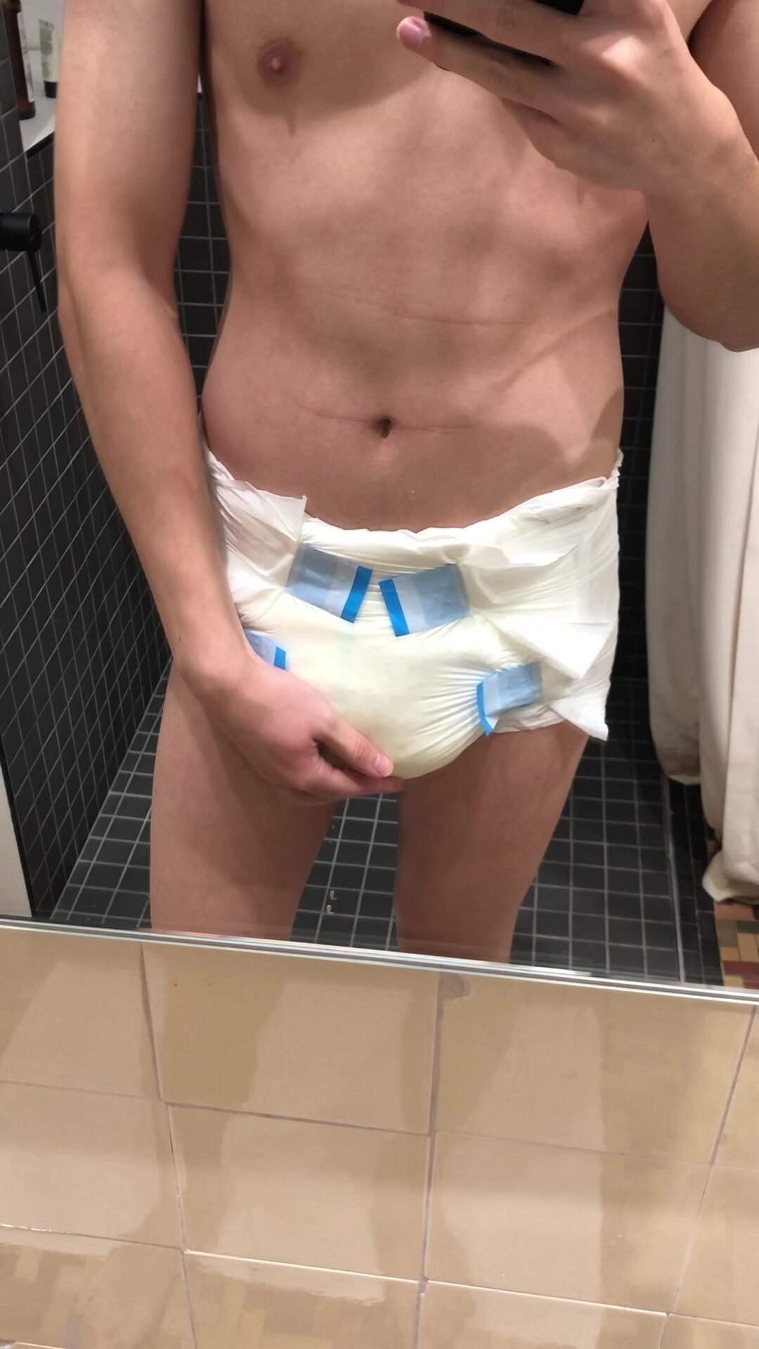 Cute boy shows off wet diaper