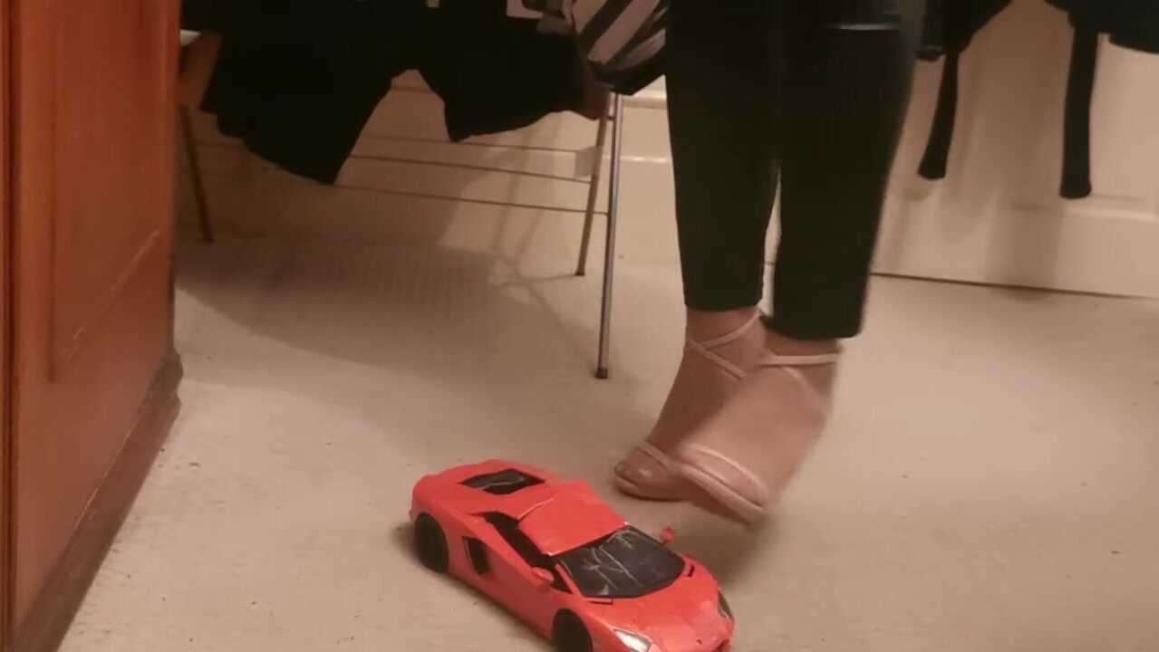 crushing a new toy car in two pairs of high heels