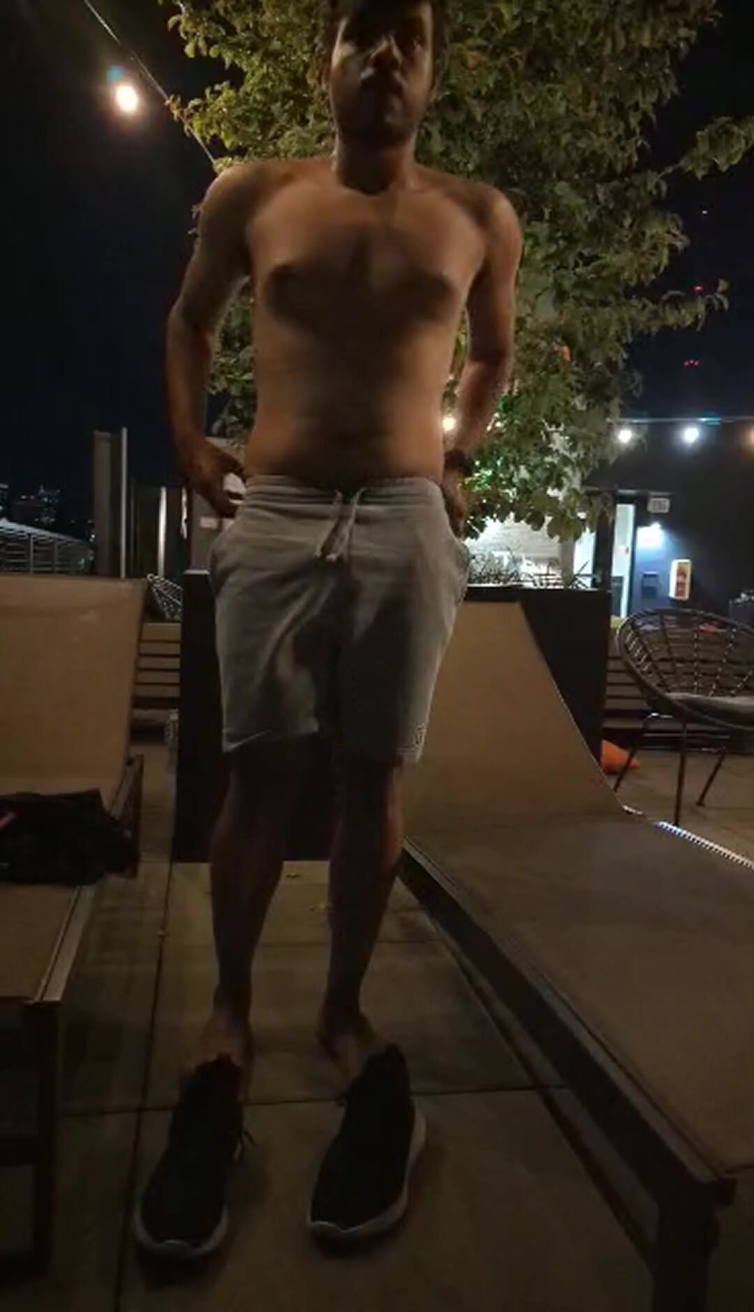 Guy strips on rooftop