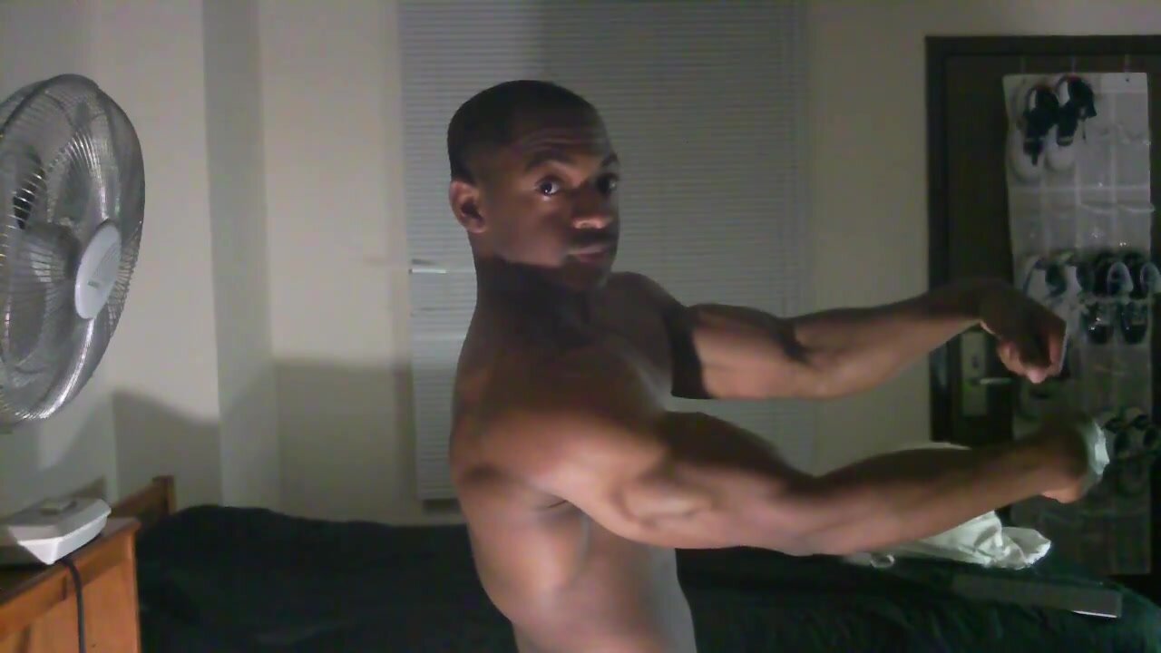 Black young muscle posing