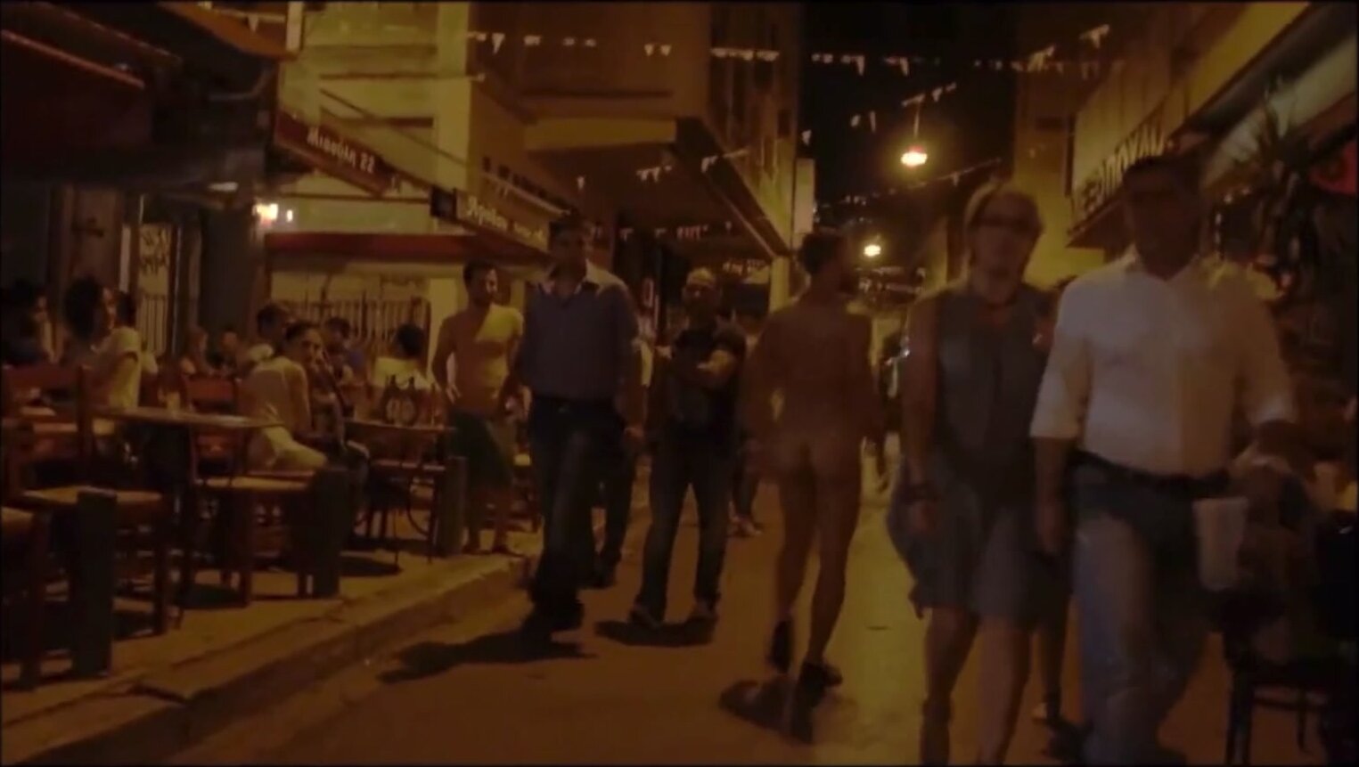 Naked Italian guy walks through crowds in Ibiza