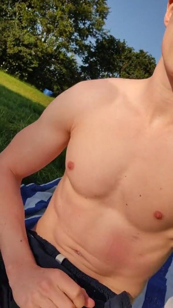 Uncut twink jerks off in public park and cums in grass