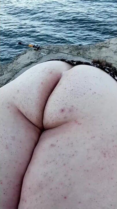 MILF flashing ass by the water