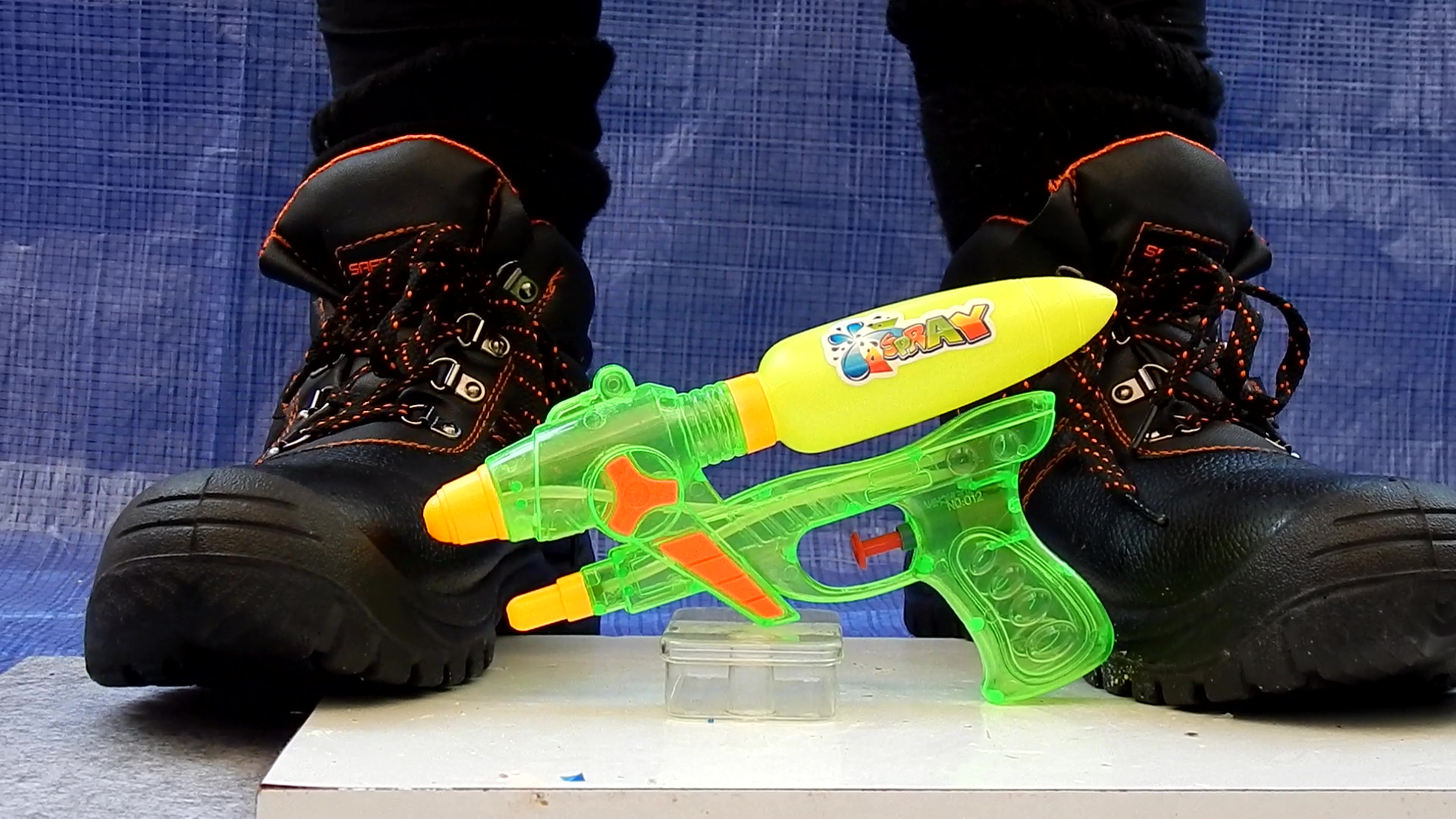 Crushing toy watergun with hard work boots