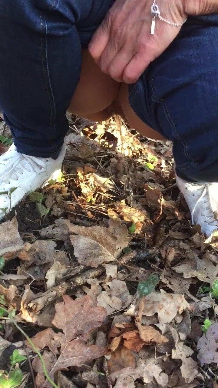 Shaved pussy squat pees on leaves in the yard