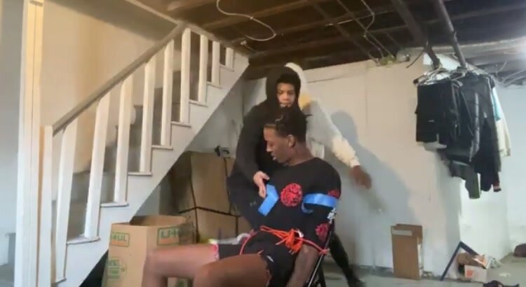 Boy duct taped to chair by friends