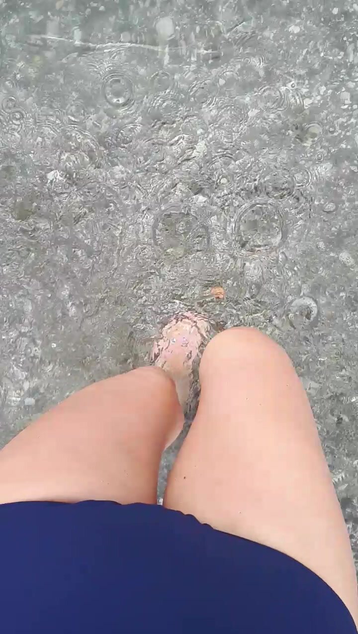 Girl peeing on beach