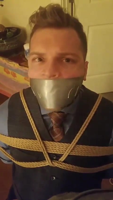 suited tape gagged and chair bound