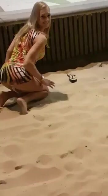 blonde masturbates on VERY public beach