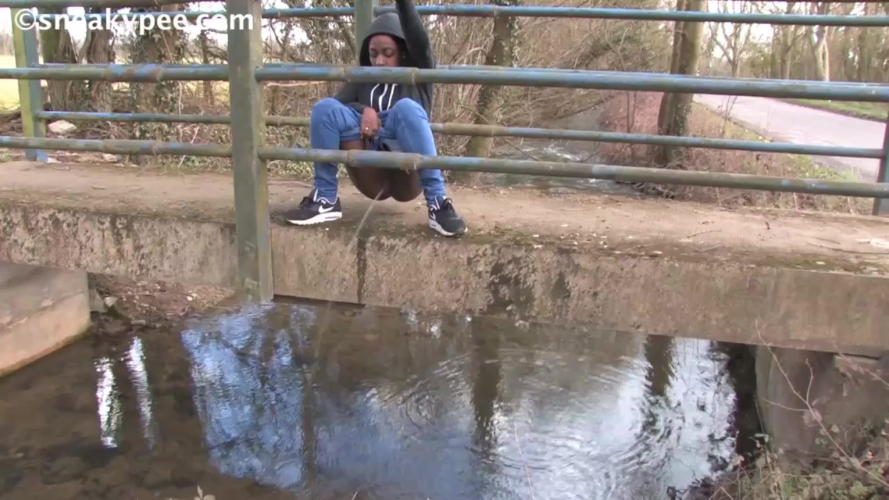 Ebony Savvy peeing into river