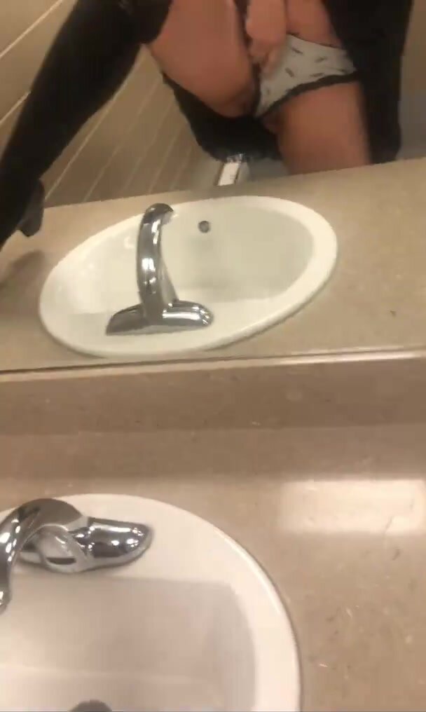 Goth girl sprays a quick bast in public bathroom sink