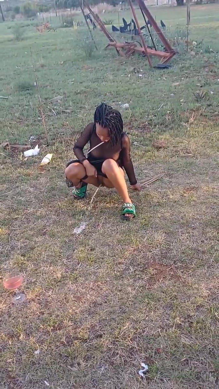 African cutie relieves herself in a grass field