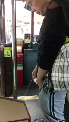 A man pissing inside HK tramways