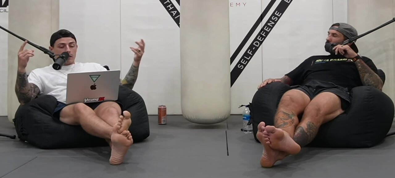 Two guys show off their feet during podcast