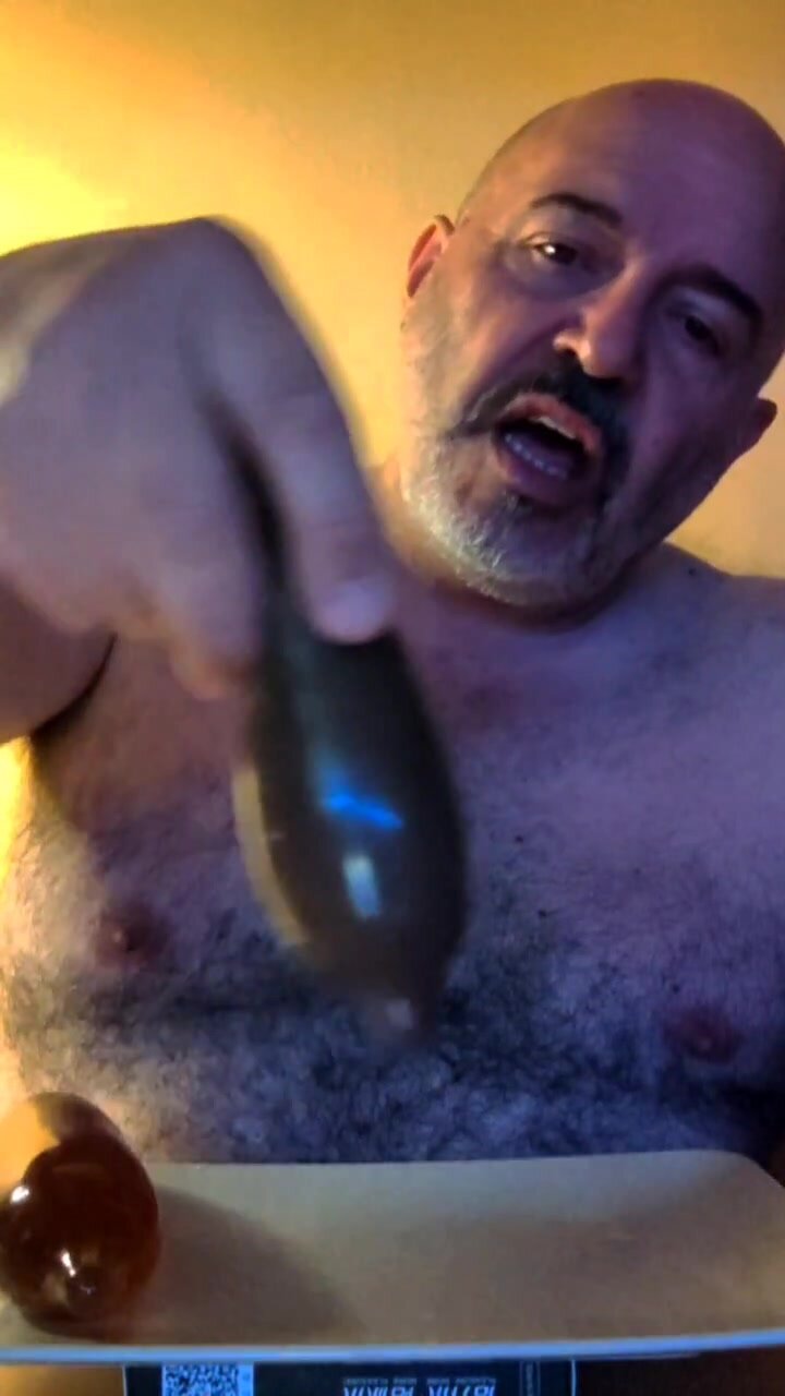 Exposed faggot playing with filled condoms