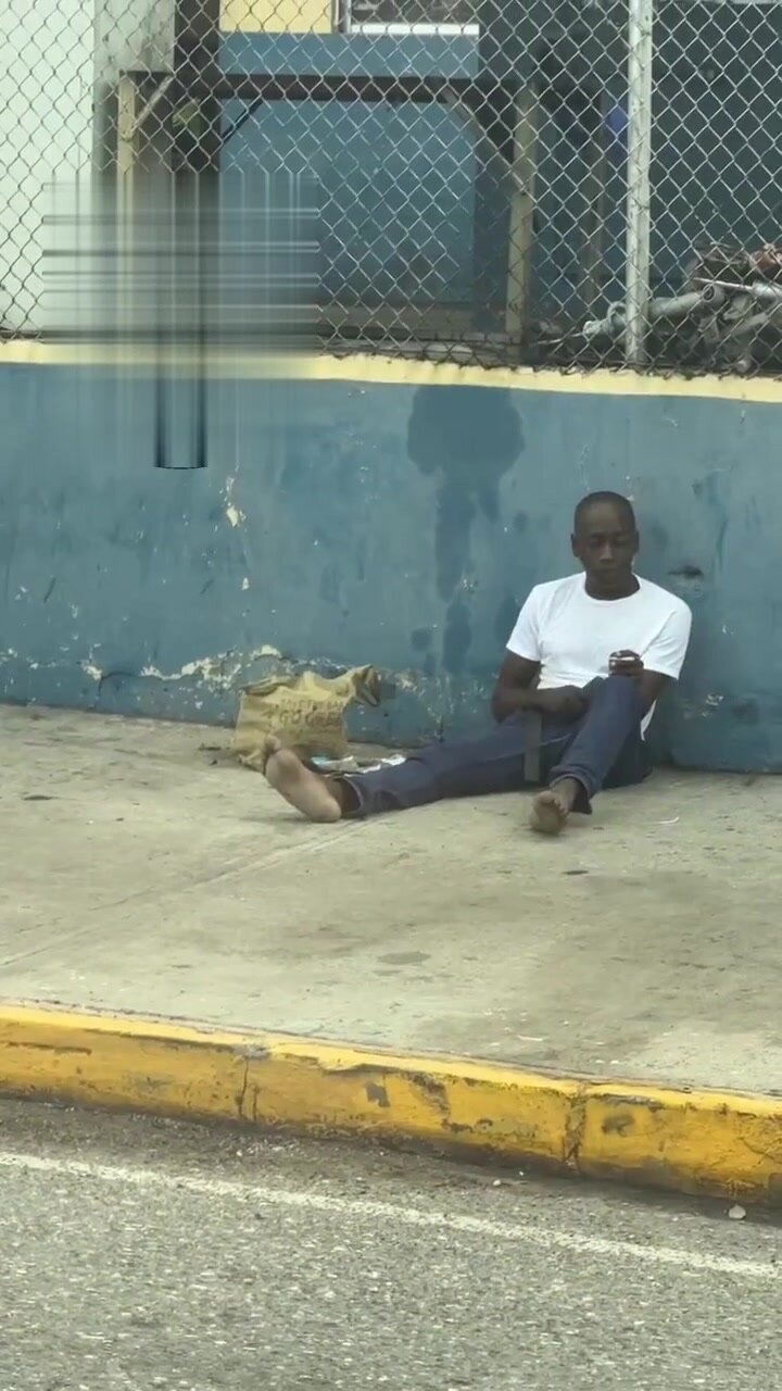 crazy jamaican man beating his dick in broad daylight