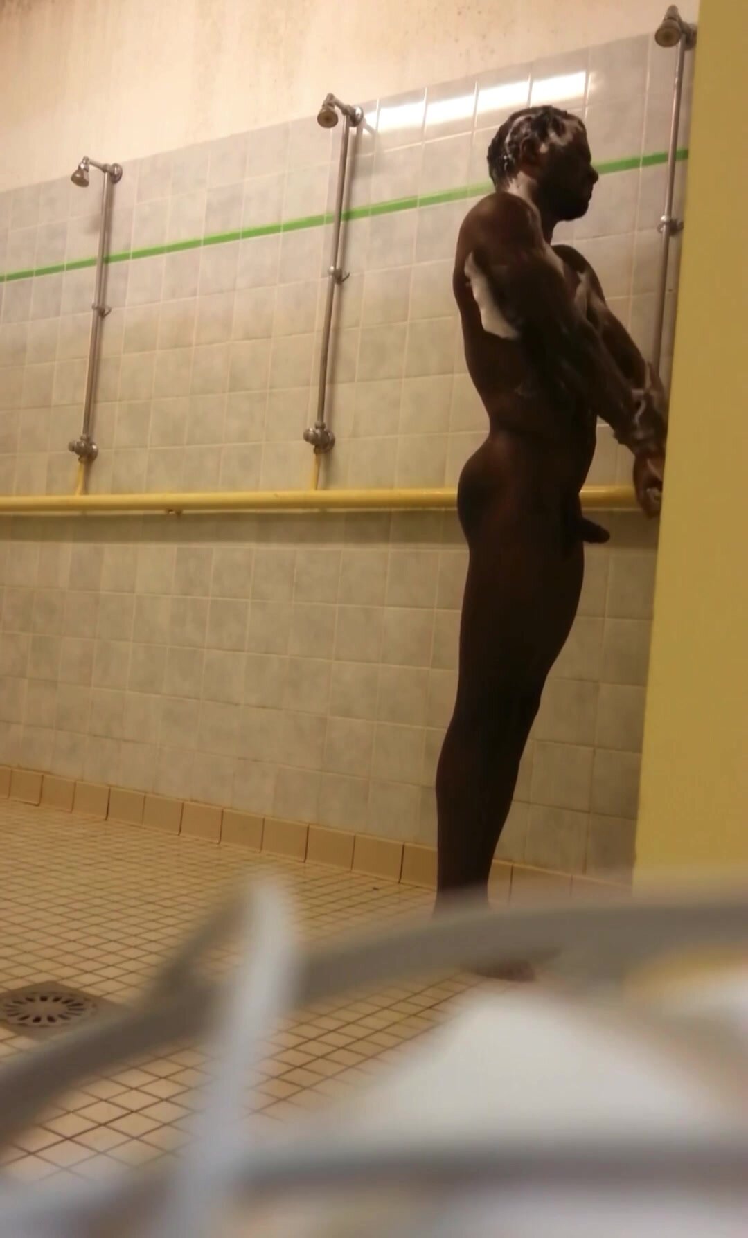 Black guy caught naked in open showers