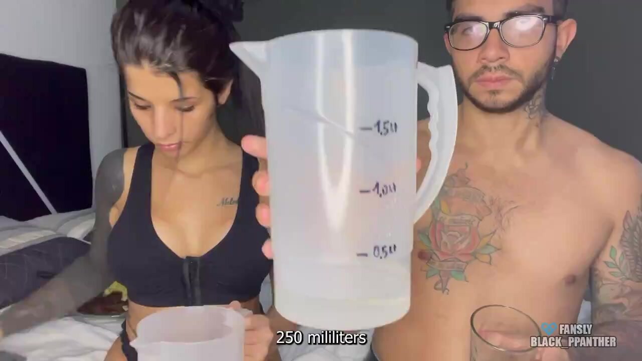 Competition: couple drinks water,holds,measures amount