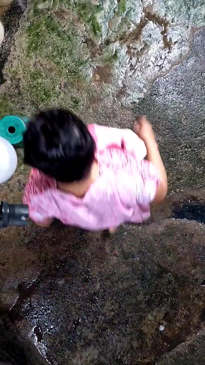 Malaysian woman water washes vagina (possibly peeing)