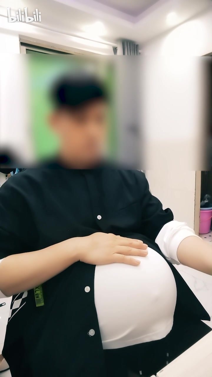 Pregnant man in office