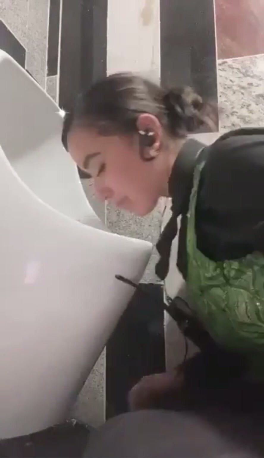Security guard cleaning the urinal