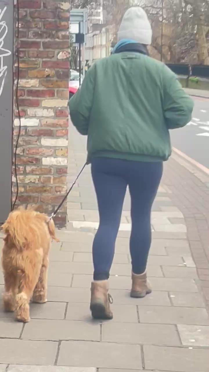 Sexy dog walker in blue leggings