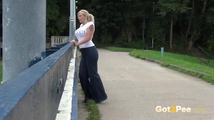 A bit plump big breasted amateur blondie pisses on the bridge