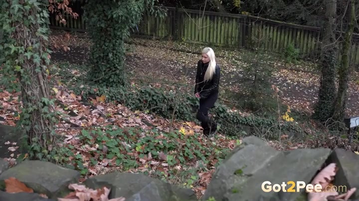 Beautiful blonde girl goes pee outdoors