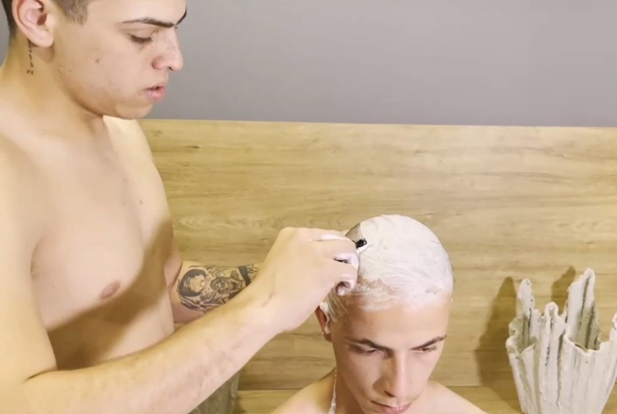Two guys shaving their heads, but...
