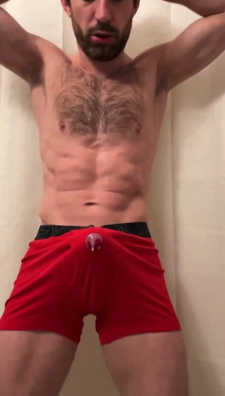Muscular man is cumming through his boxers