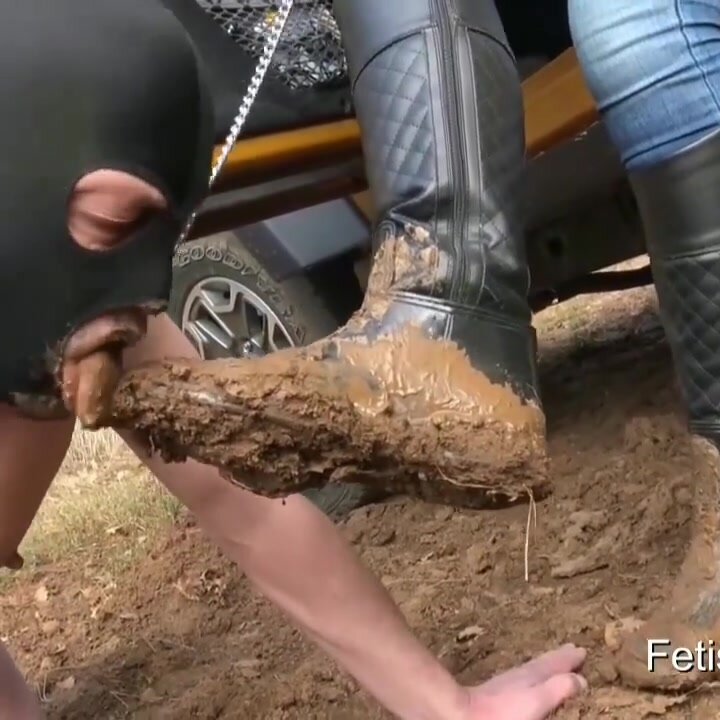 slave eats mud from a lady's dirty shoe