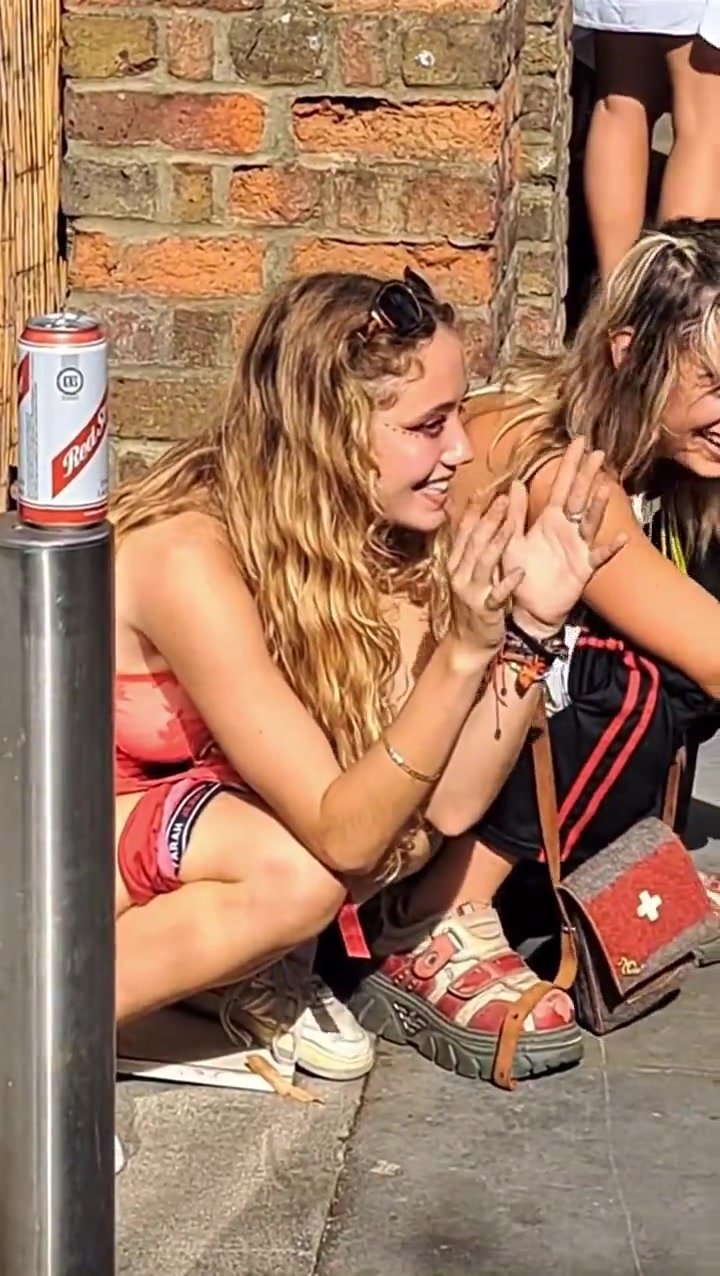 Cute friends relieve themselves on the crowded sidewalk