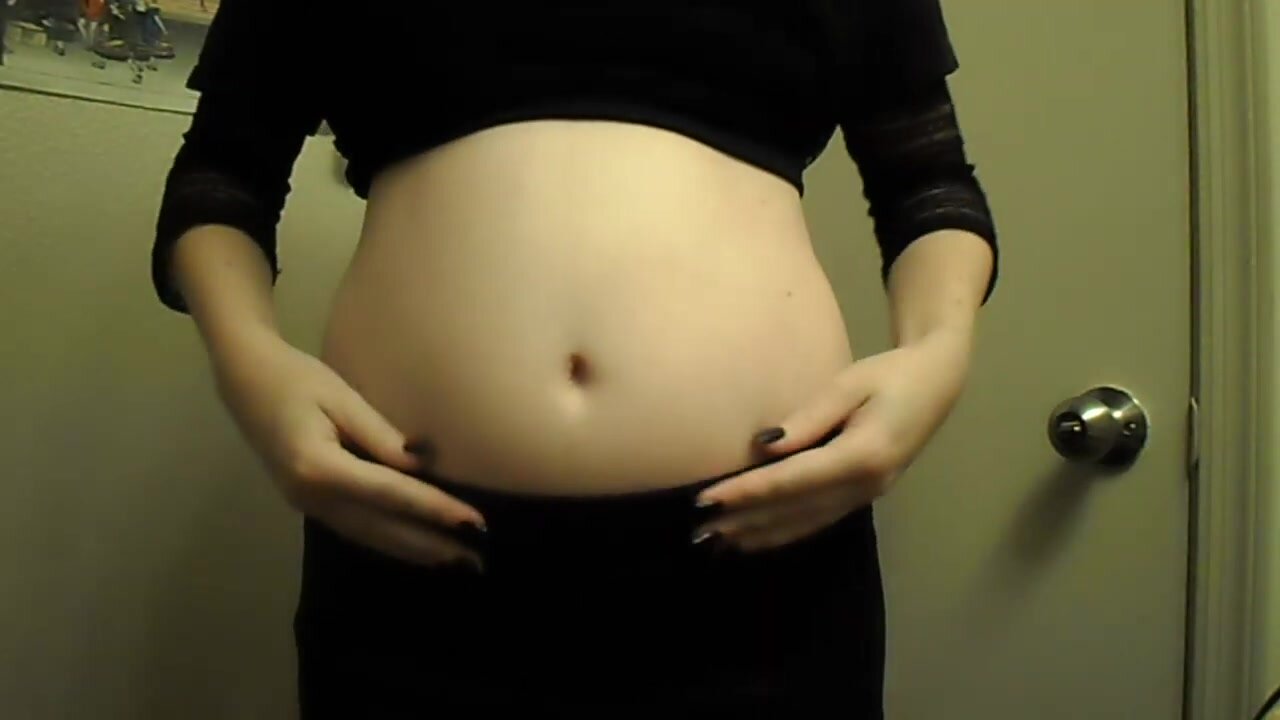 Girl rubbing her bloated belly