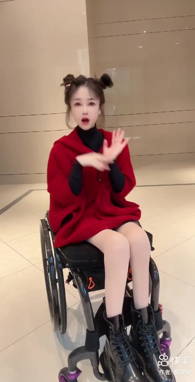 Cute paraplegic girl dancing in wheelchair