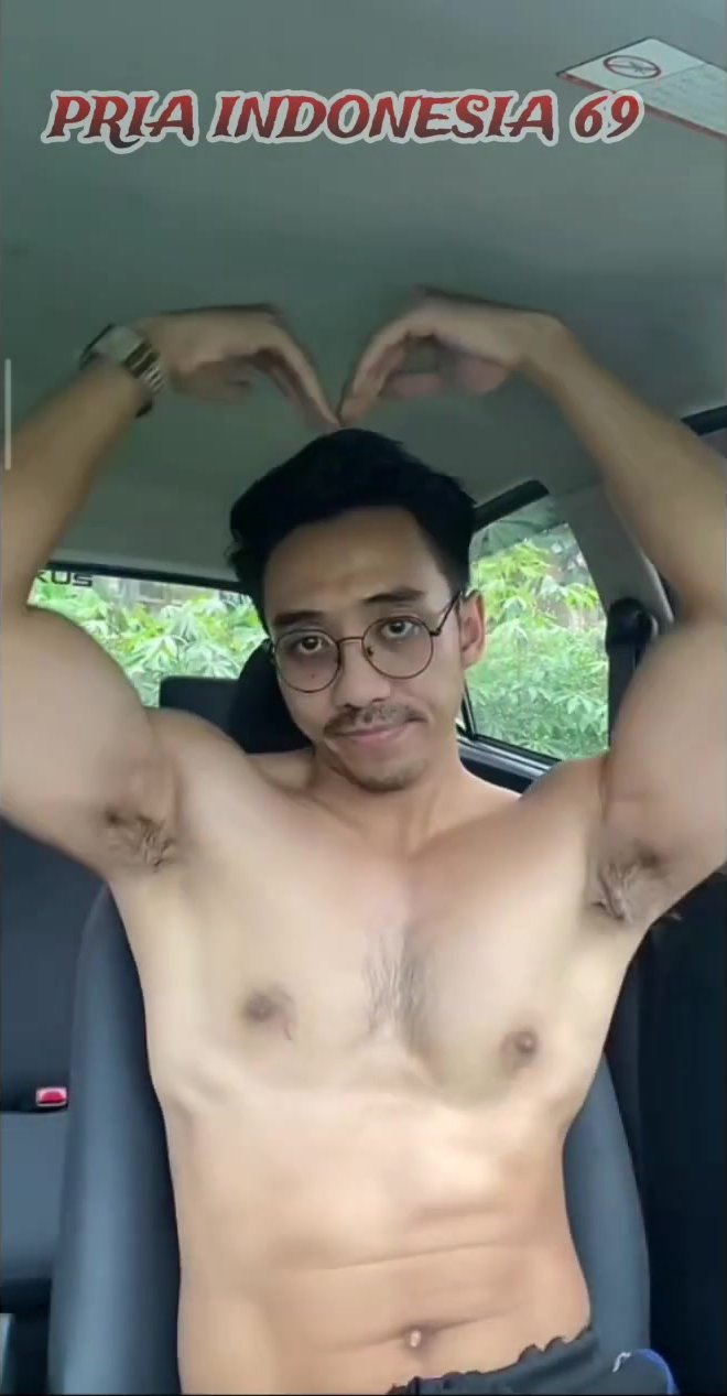 Asian flexing muscle in the car
