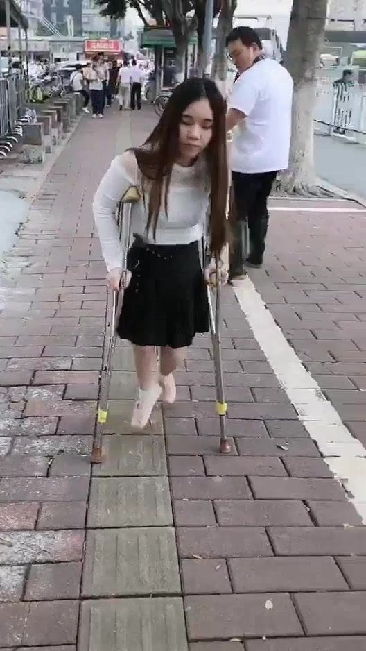 polio girl walks with crutches