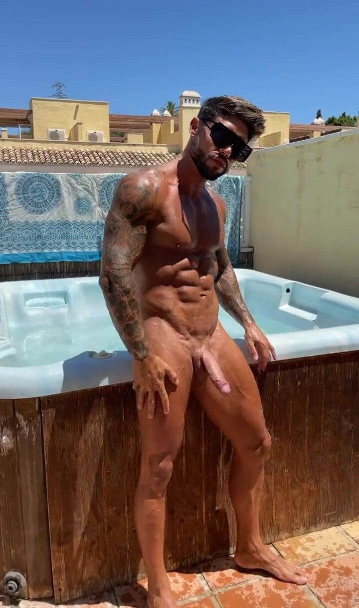 Fit hunk shows his massive uncut cock at rooftop pool