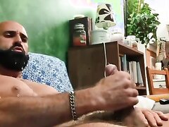 Bearded man shoots cum all over beard, face, and body