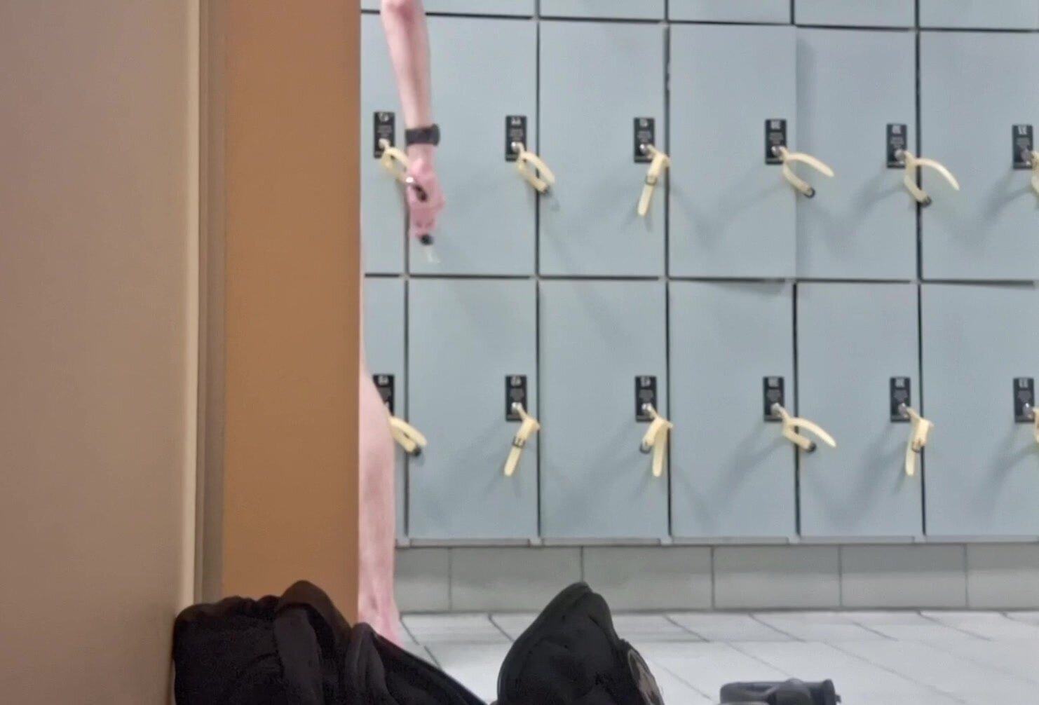 Guy grabbing key from locker nude
